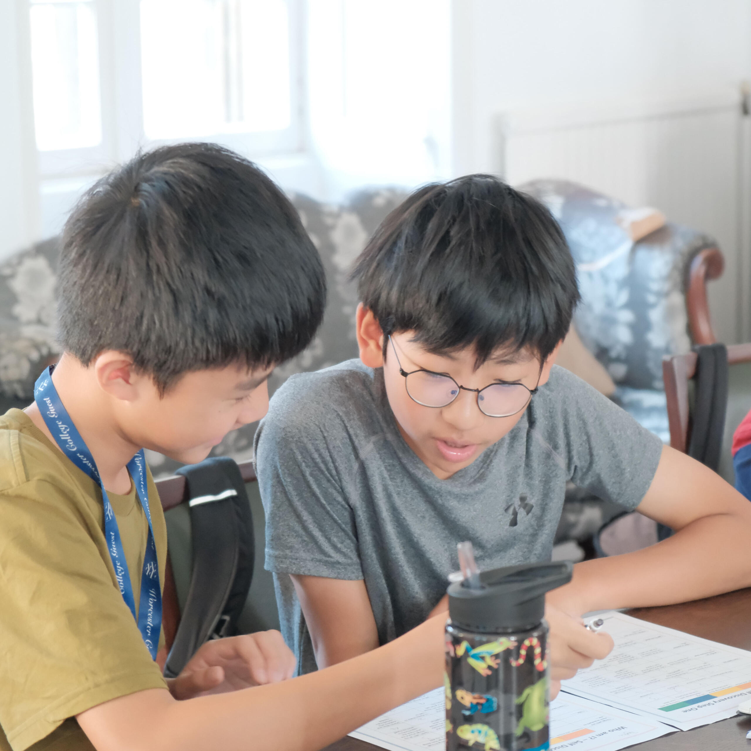 Two boys learning and working together.